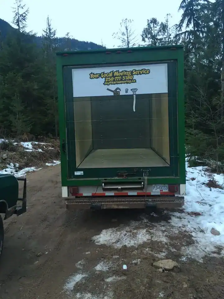 Green moving truck with open cargo area for local moving services in Oregon.