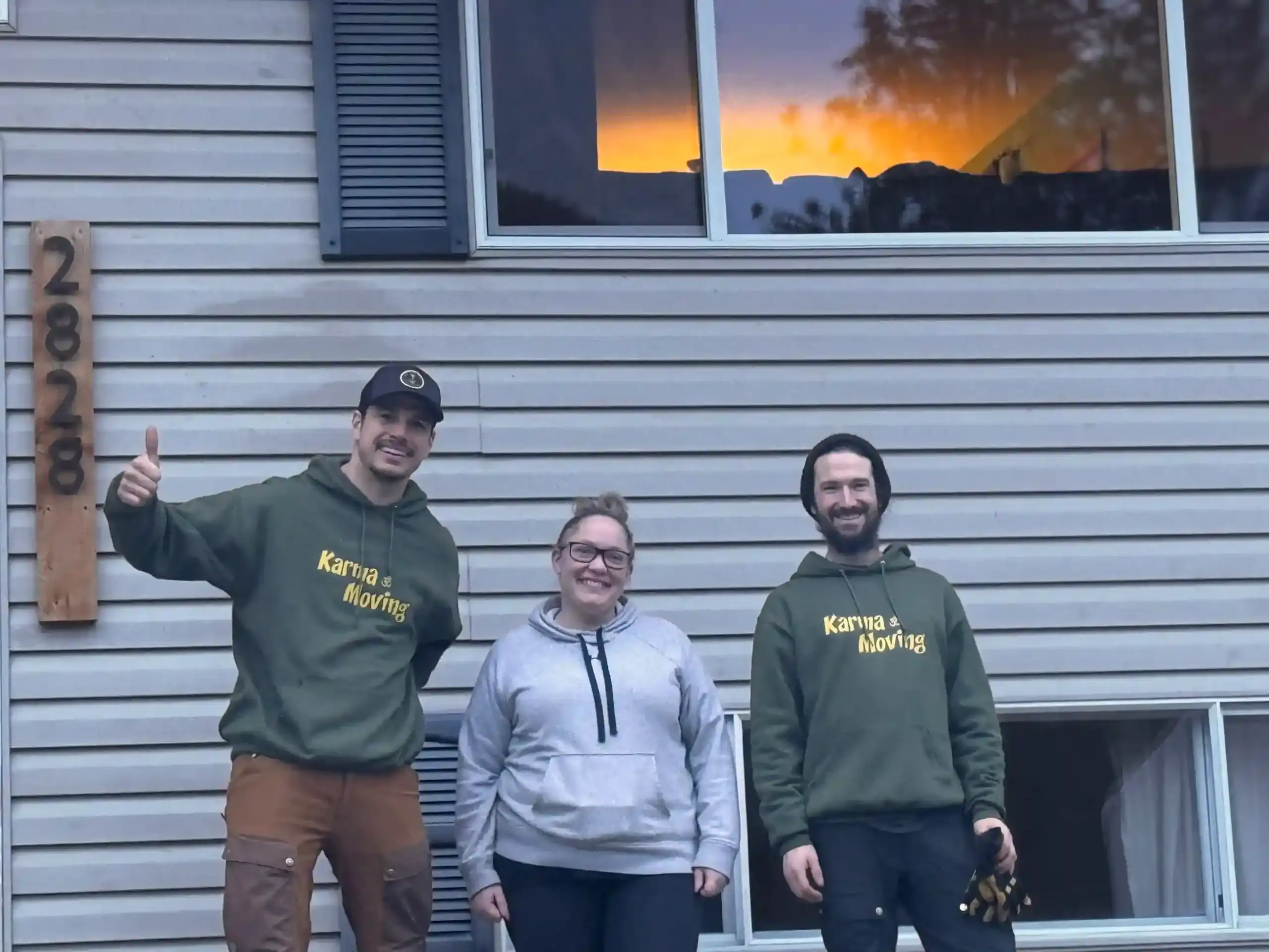 Moving professionals from Karma Moving smiling outdoors.